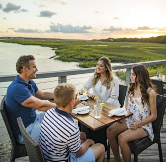 familing of four dining outside