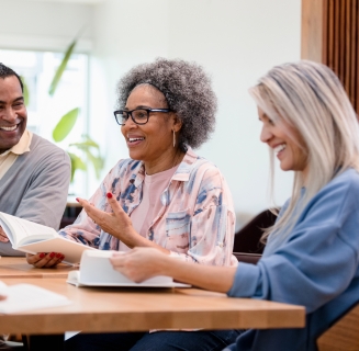 group of people smiling during a meeting