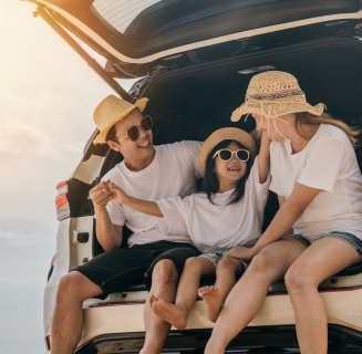 family sitting in the back of a car
