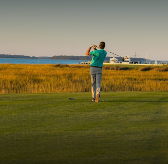 man teeing off at a golf course