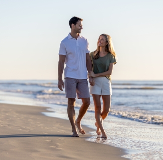 Couple Walking Down Beach 