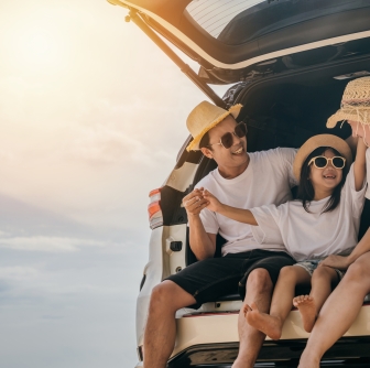 family sitting in the back of a car