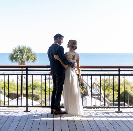 couple standing on an outdoor balcony