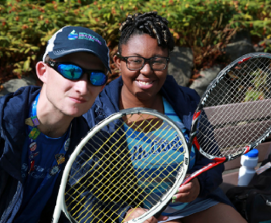 boy and girl playing tennis