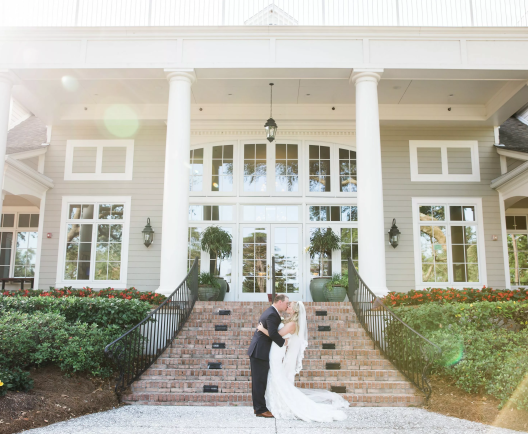 couple embracing in frnt of a building