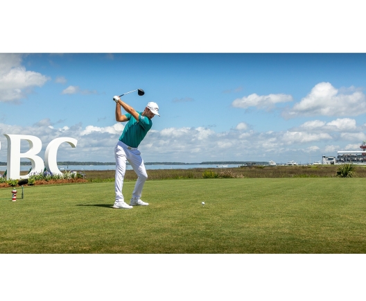 man teeing off at a golf course