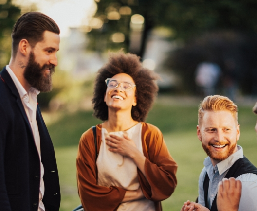 Smiling business people outdoors in the street on coffee break