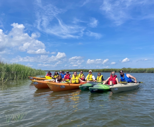 kayakers lined up in the water 