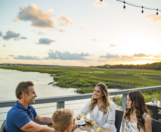 family eating by the water