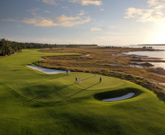 Aerial golf course shot with people playing 