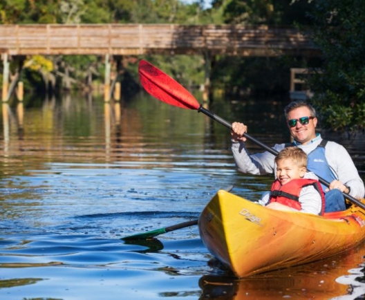 man and child kayaking 