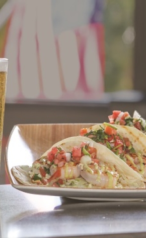 tacos on a table with a beer