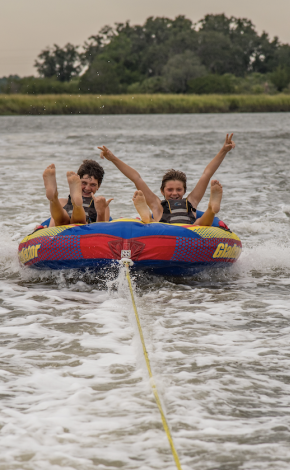 kids on a tube in the water