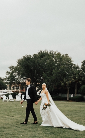 couple walking on a golf course after getting married