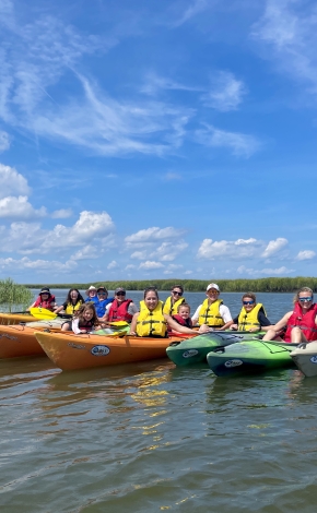 kayakers lined up in the water 