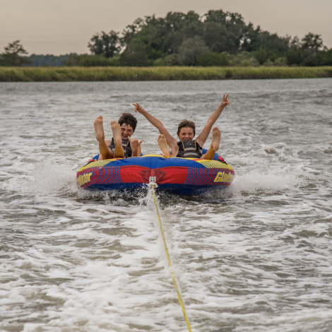 kids on a tube in the water