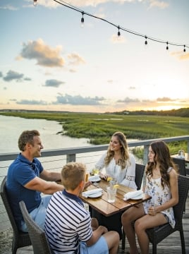 familing of four dining outside