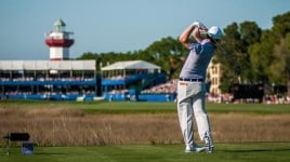Golfer holds his stance post swing