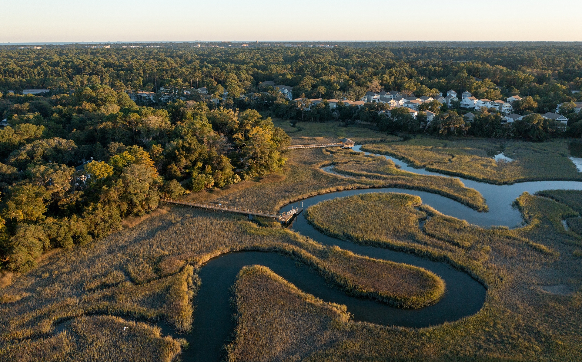 a winding marsh with a dock