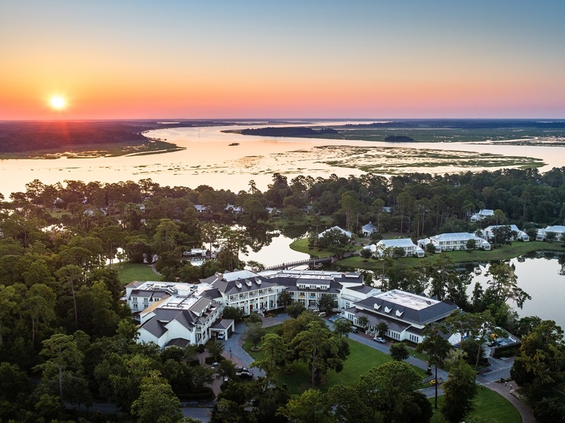 sunset with view of hotel and the water 
