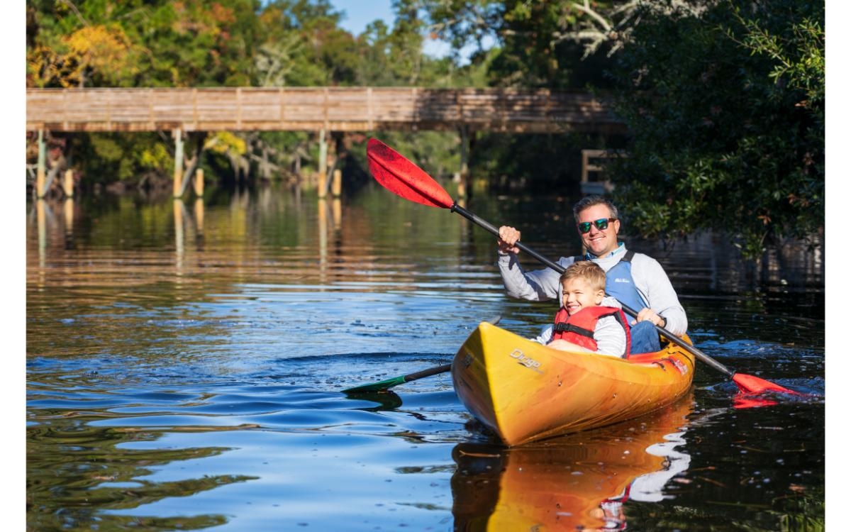 man and child kayaking 