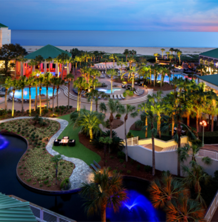 Aerial shot of resort featuring water features, outdoor pools, and patio areas