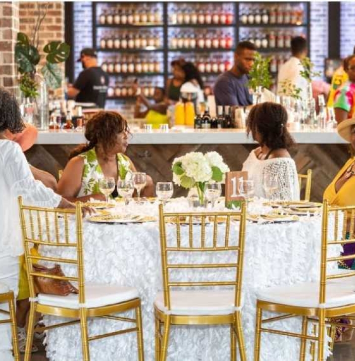 Four ladies sat at a table posing for camera