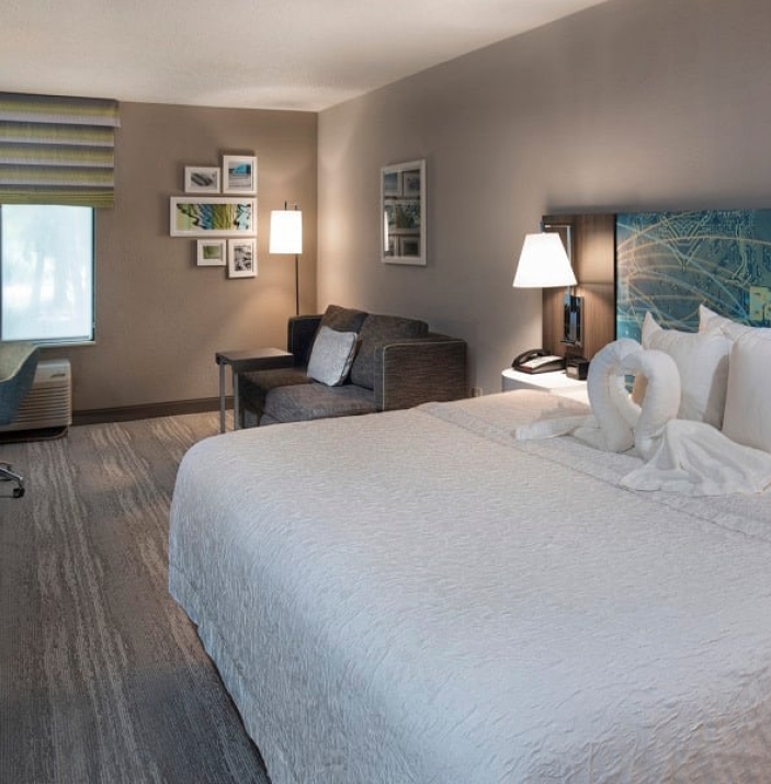 Hampton Inn room with towel swans on bed