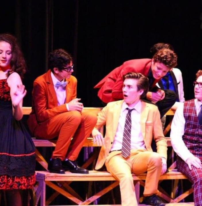 Actors on stage in costume mid scene